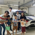 ONE students and teachers posing in front of a police car